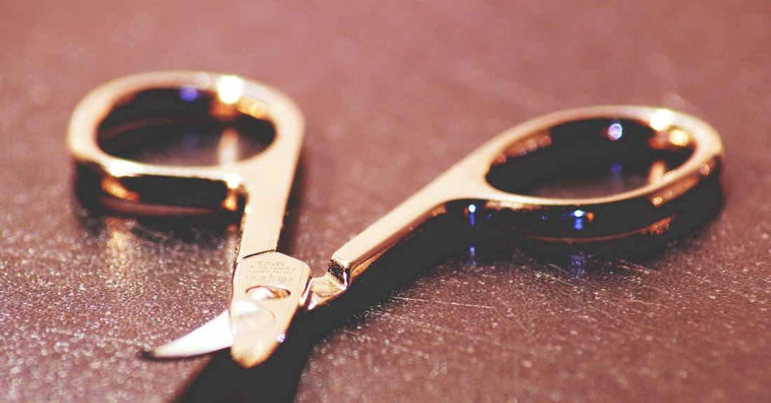 Close-up of professional stainless steel cuticle scissors with curved blades on a clean white background, showcasing the best cuticle scissors UK 2026.