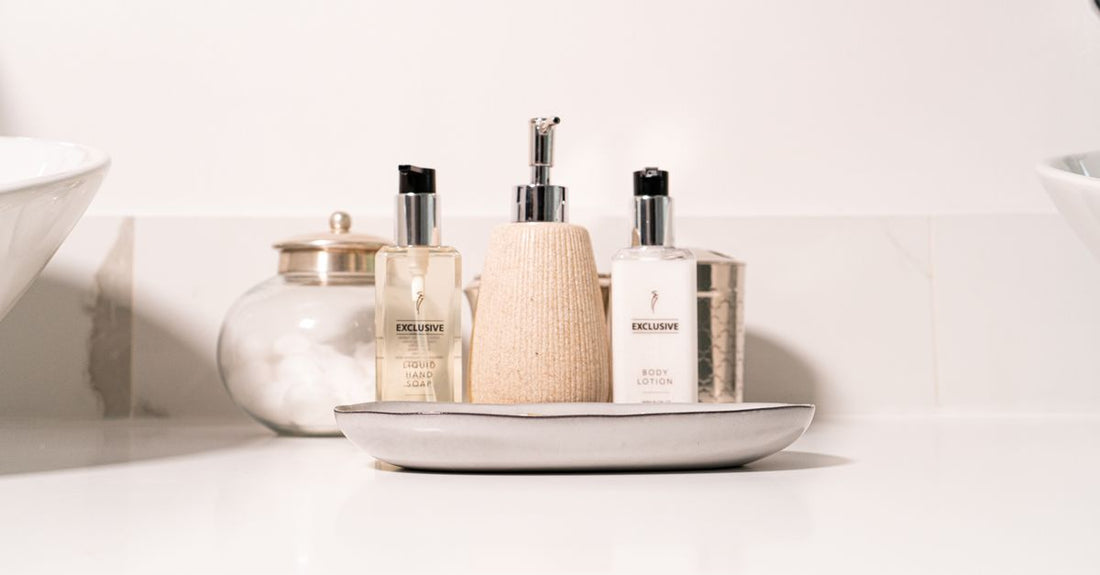 A collection of the best body washes UK 2026 arranged on a marble shelf, showcasing different bottle designs and textures for various skin needs.