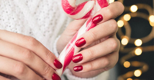 A collection of colourful nail polish bottles and nail art tools arranged on a white background, illustrating a nail art & polish buying guide.