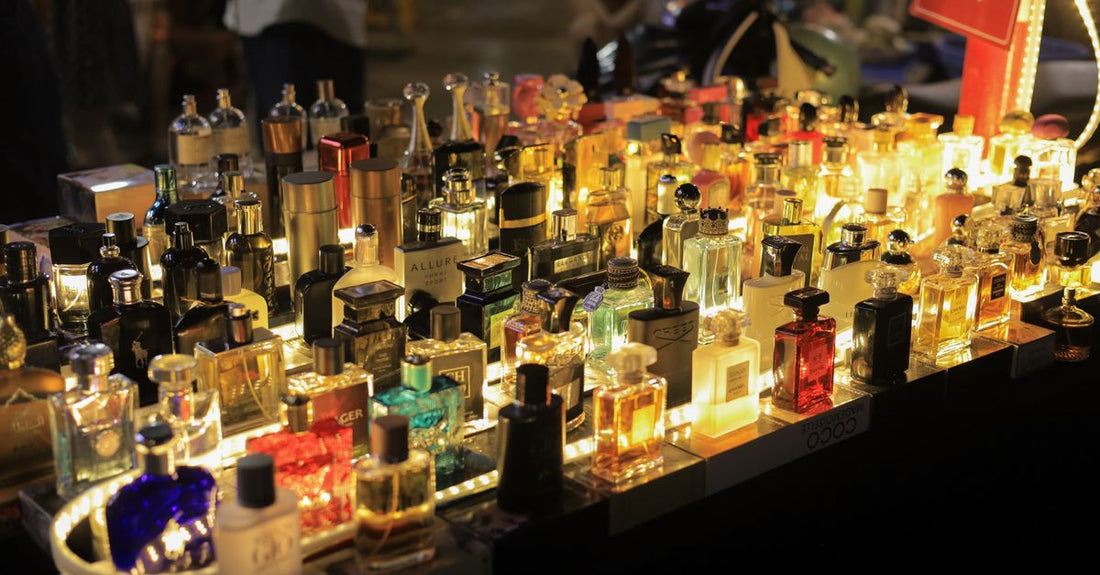 Assorted eau de toilette bottles lined up on a glass shelf, representing the best eau de toilette UK 2026 selection for value hunters.