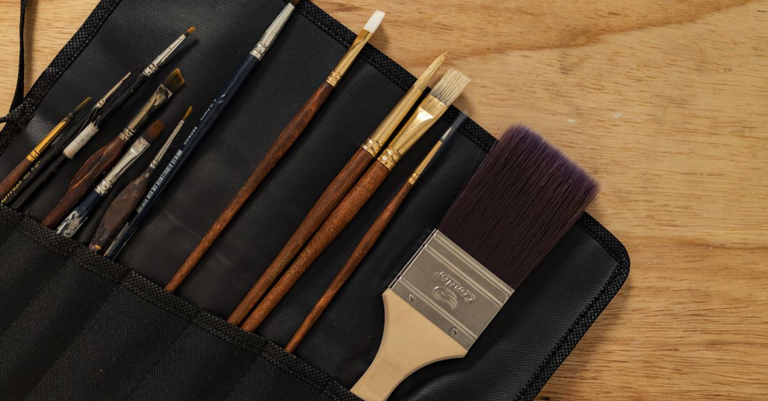 A selection of the best brush sets 2026 laid out on a white marble surface, showing various brush shapes and sizes.