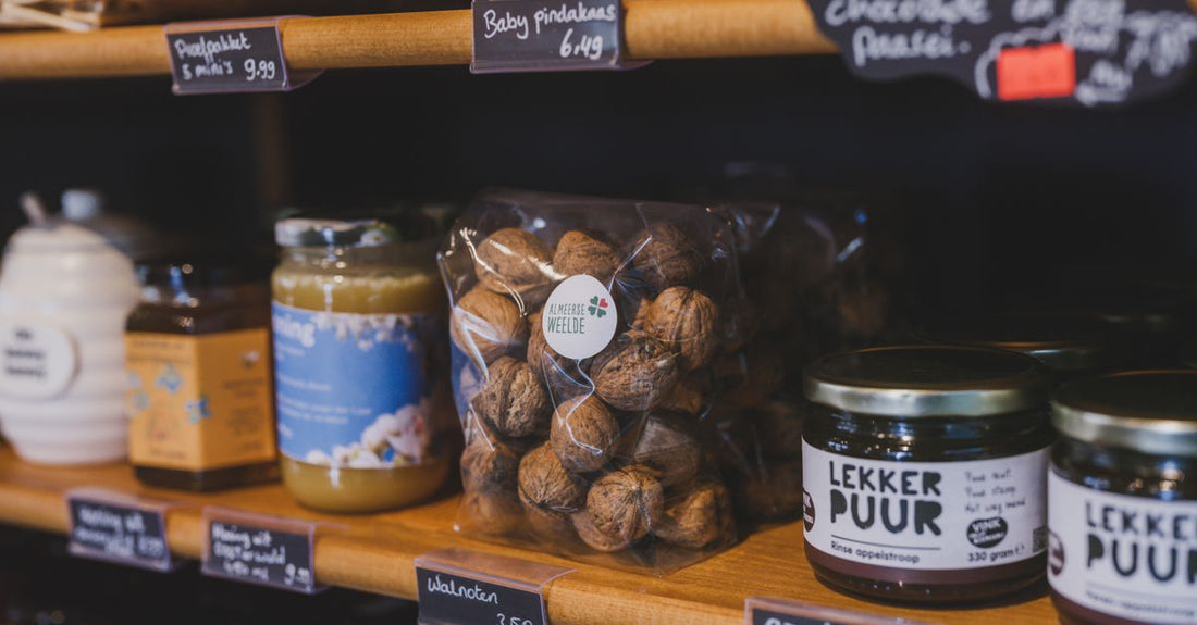 A shelf displaying various jars of the best body butters 2026, including whipped shea and cocoa butter varieties, with natural ingredients visible.