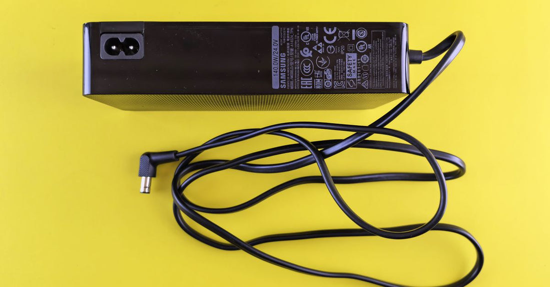 A selection of electric trimmer chargers and hard travel cases arranged on a clean surface, illustrating how to choose accessories for UK grooming routines.