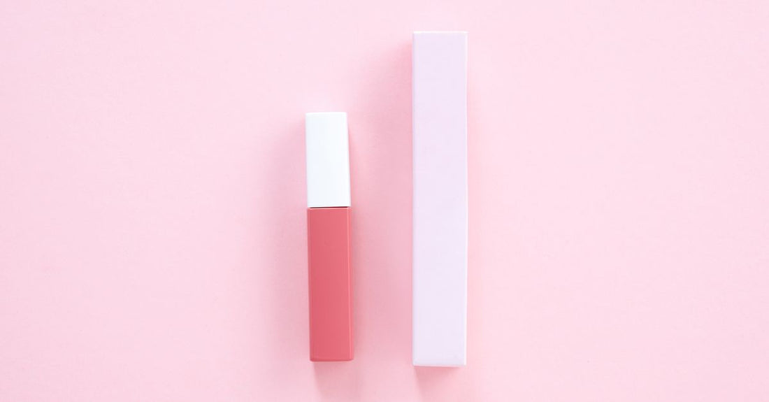Collection of best lip glosses UK 2026 arranged on a marble surface with glossy finishes reflecting light.