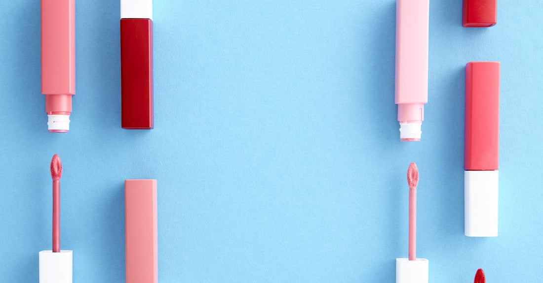 Assorted lipstick tubes arranged on a white marble surface, illustrating how to choose lipstick UK variety.