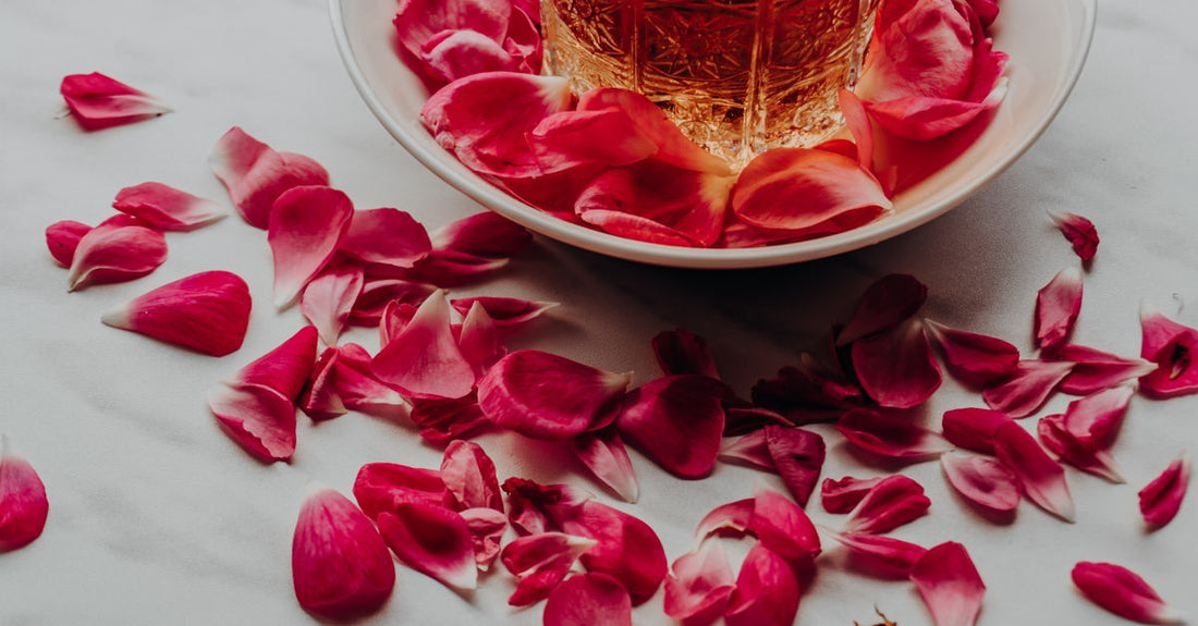 A rose water hydrosol mist bottle on a marble surface, part of a mists & hydrosols buying guide for UK skincare enthusiasts.
