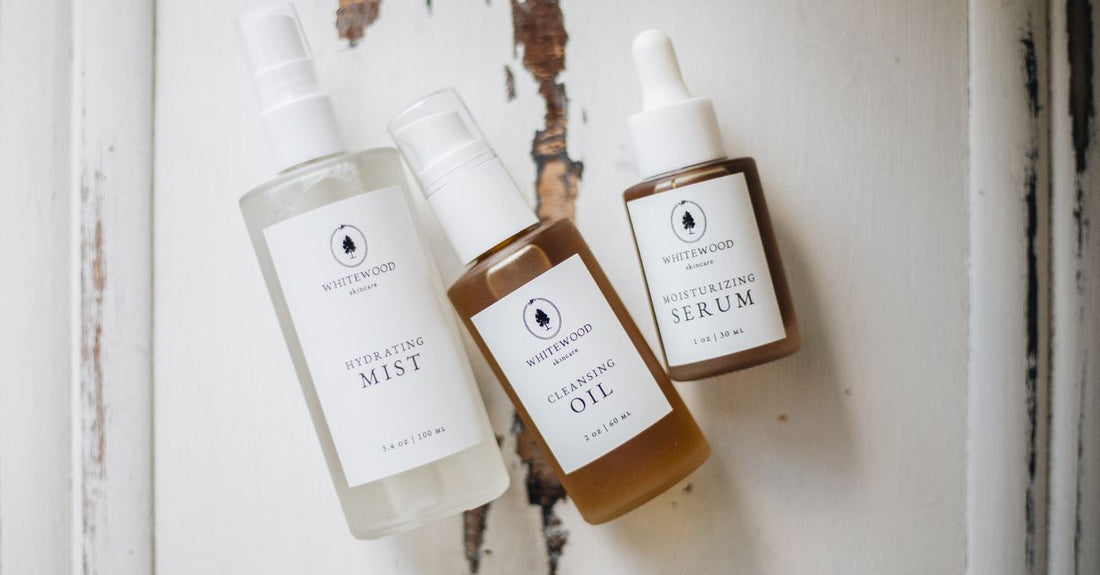 Selection of face mist bottles on a light surface, showing how to choose face mists UK for different skin types