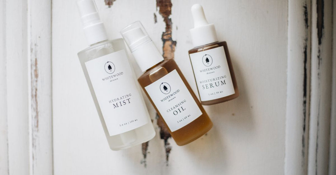 A collection of best mists & hydrosols UK 2026 bottles on a marble surface with botanical extracts.