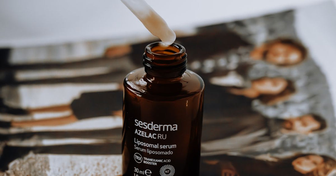 A clear glass bottle of hyaluronic acid serum next to a dropper on a white marble surface, illustrating how to use hyaluronic acid serum in a UK beauty routine.