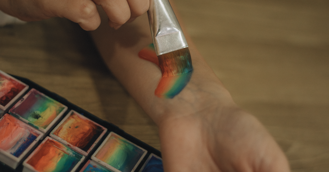 A colourful body paint palette with brushes on a white background, illustrating a body paint buying guide for UK beauty shoppers.