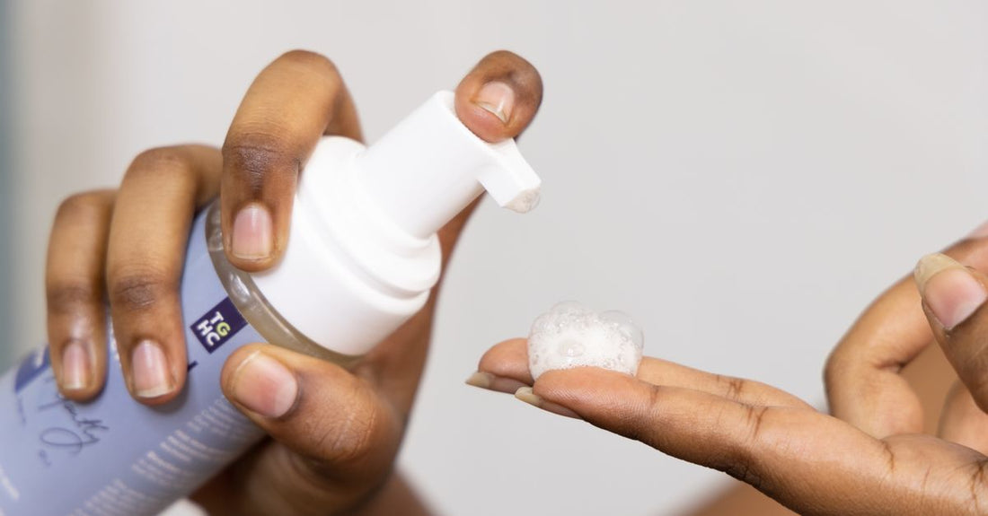 Best face wash for acne prone skin UK: a gentle foaming cleanser bottle on a light marble surface, representing effective daily acne care.