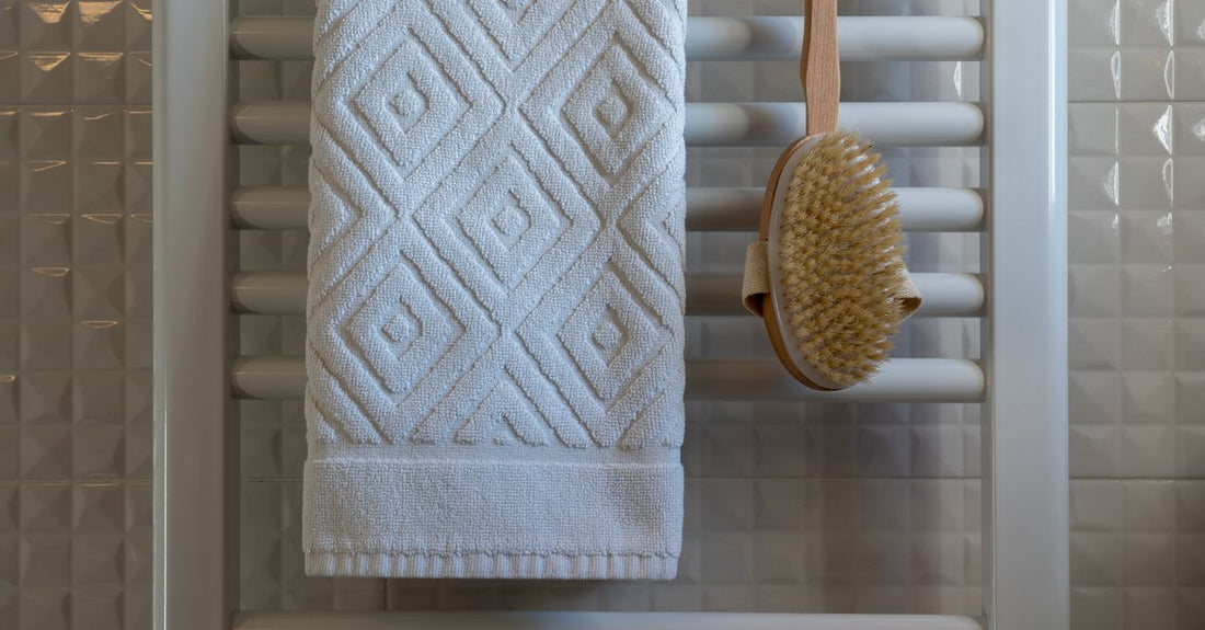 A flatlay of best bath & body brushes 2026 including natural bristle and silicone options on a white background.