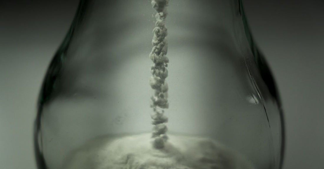 A jar of professional bleach powder for hair lightening, illustrating how to bleach hair without damage.