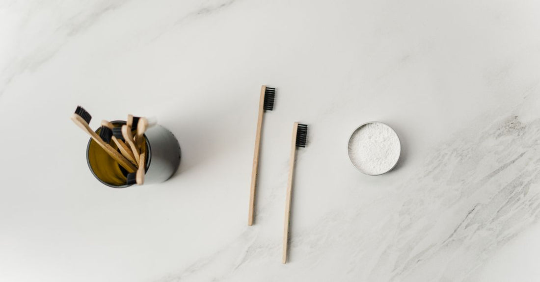 Assortment of natural deodorant sticks and jars on a marble surface, UK edition