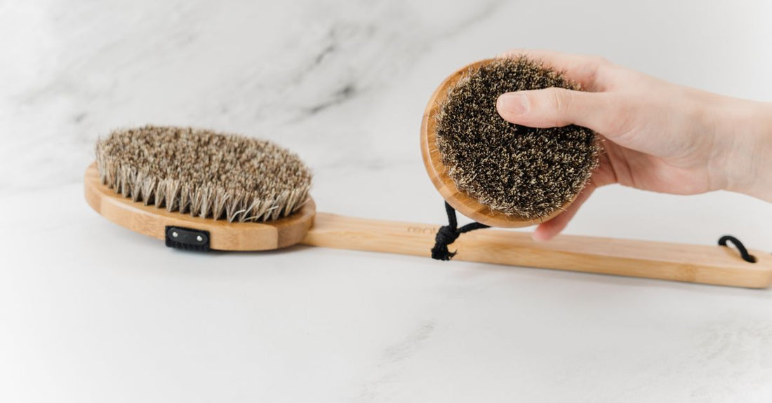 Best bath brush for exfoliation UK: natural bristle body brush with long bamboo handle on white background