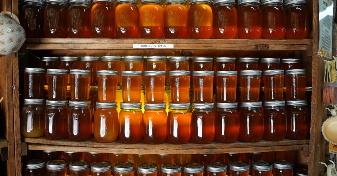 A selection of body scrub jars on a bathroom shelf, illustrating how to choose body scrubs for different skin types.
