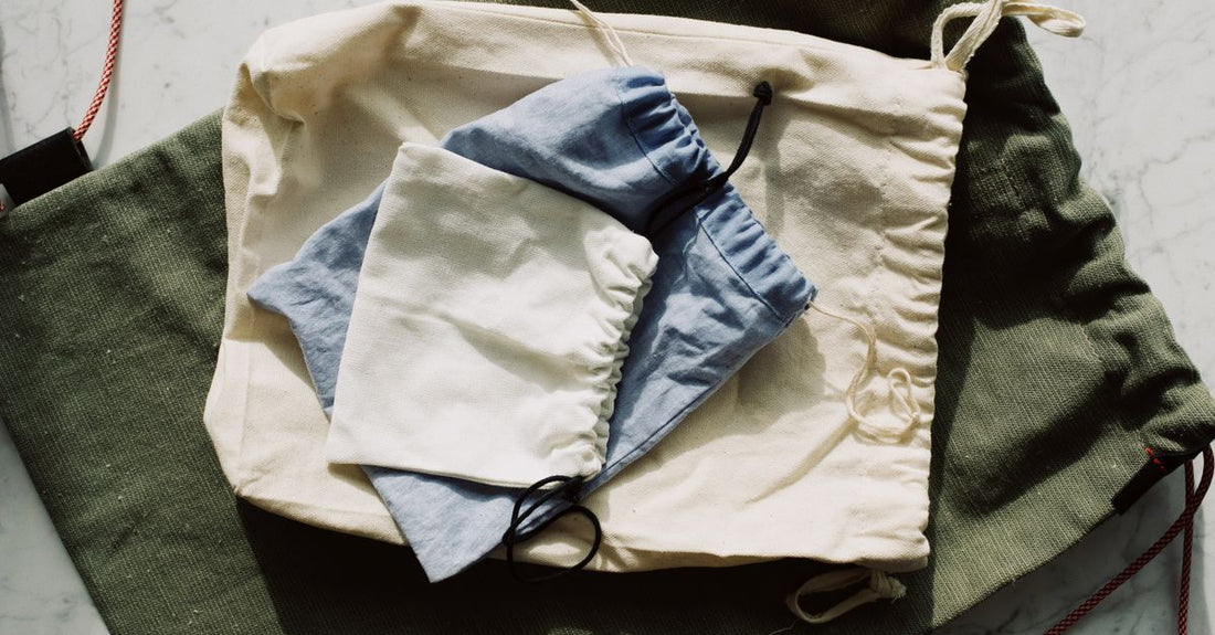 A flatlay of various cosmetic bags in different sizes and materials, illustrating how to choose cosmetic bags for your routine.