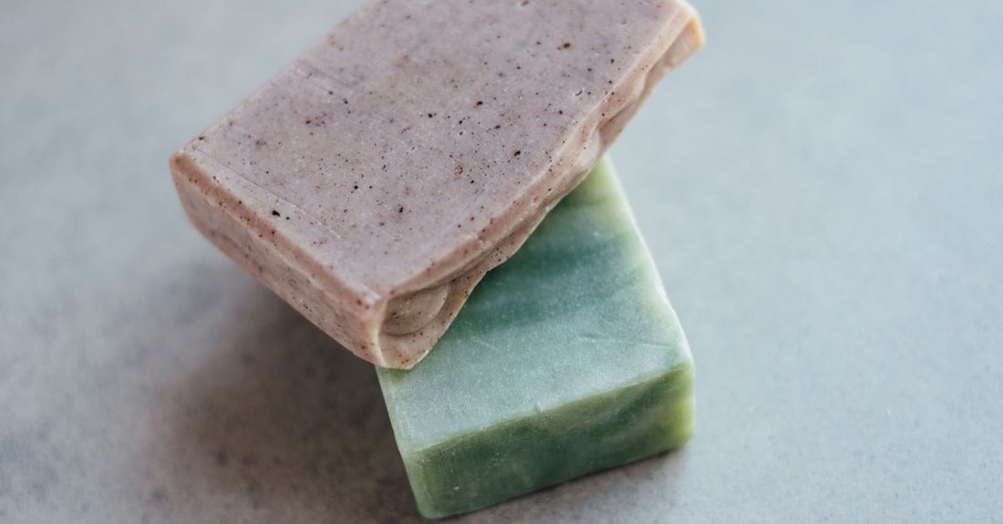 A selection of natural soap bars arranged on a marble surface to illustrate how to choose bars UK