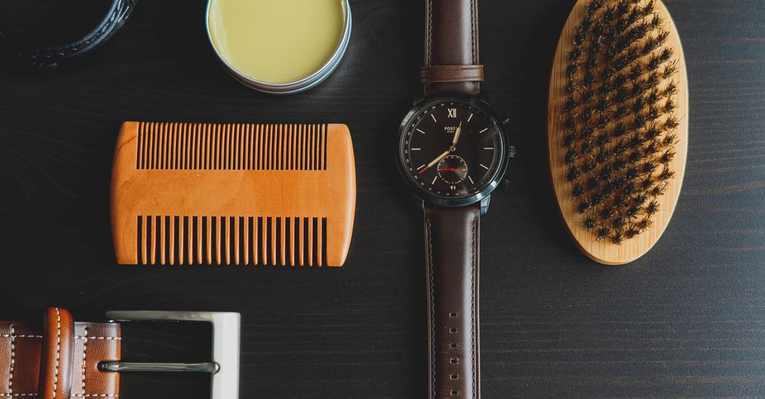 How to use beard balm — a tin of natural beard balm and a wooden comb on a textured surface.