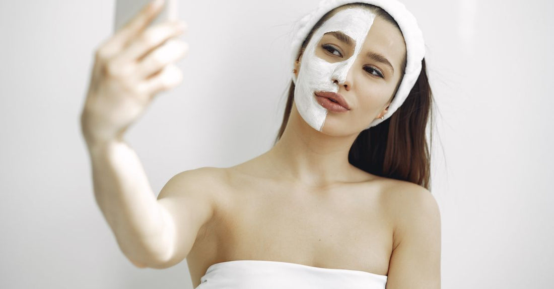 A selection of face masks in jars and tubes on a bathroom shelf, illustrating a masks buying guide for UK skincare routines.