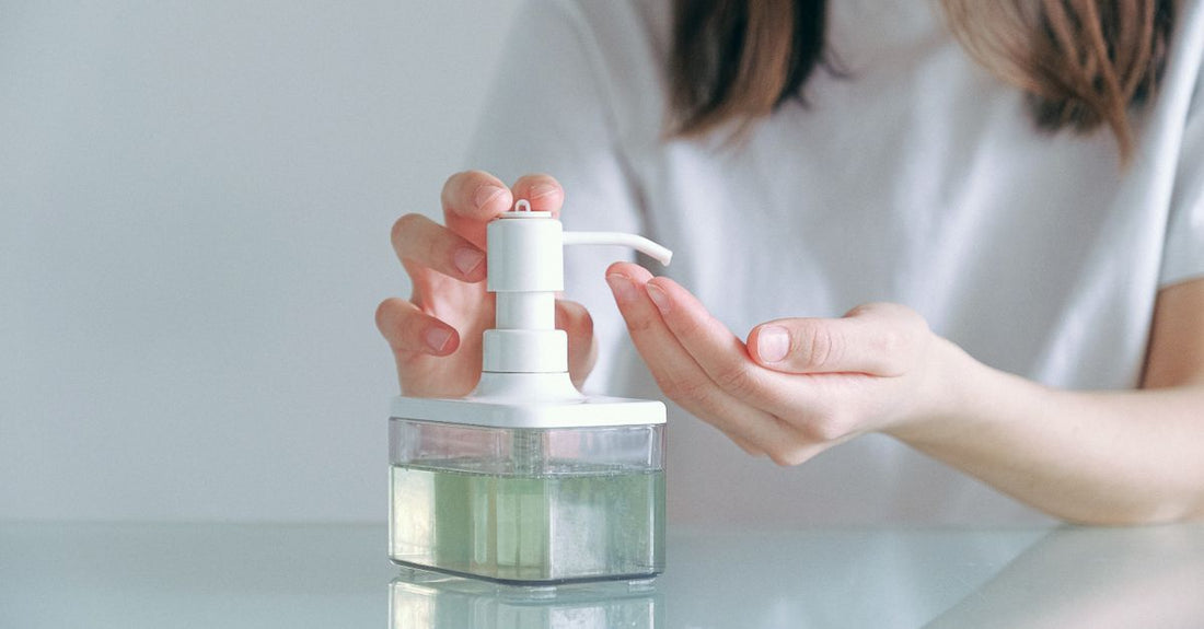 A selection of hand wash bottles on a marble surface, illustrating how to choose hand wash for different skin needs.