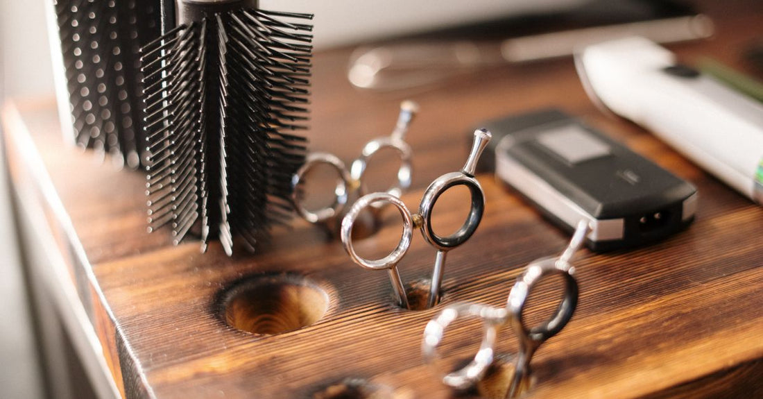 A set of black plastic clipper combs and metal guides arranged neatly on a white surface, illustrating the best clipper combs & guides 2026 for precise grooming.