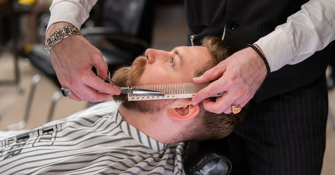 How to choose beard & mustache combs: a wooden beard comb and mustache comb resting on a dark grooming surface