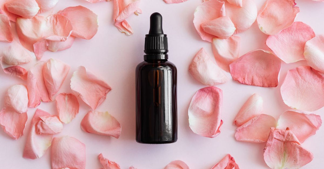 A collection of skincare bottles on a marble surface, illustrating the essentials of a face buying guide.