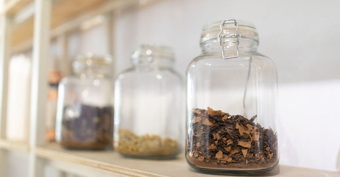 Assorted bath salts in glass jars on a bathroom shelf, illustrating a bath salts buying guide UK