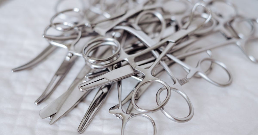 Close-up of professional stainless steel cuticle scissors on a white background, illustrating a cuticle scissors buying guide UK