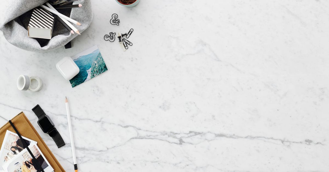 A selection of high-quality hair clips including metal barrettes, pearl clips, and acrylic duckbill clips arranged on a marble surface, illustrating a clips buying guide.
