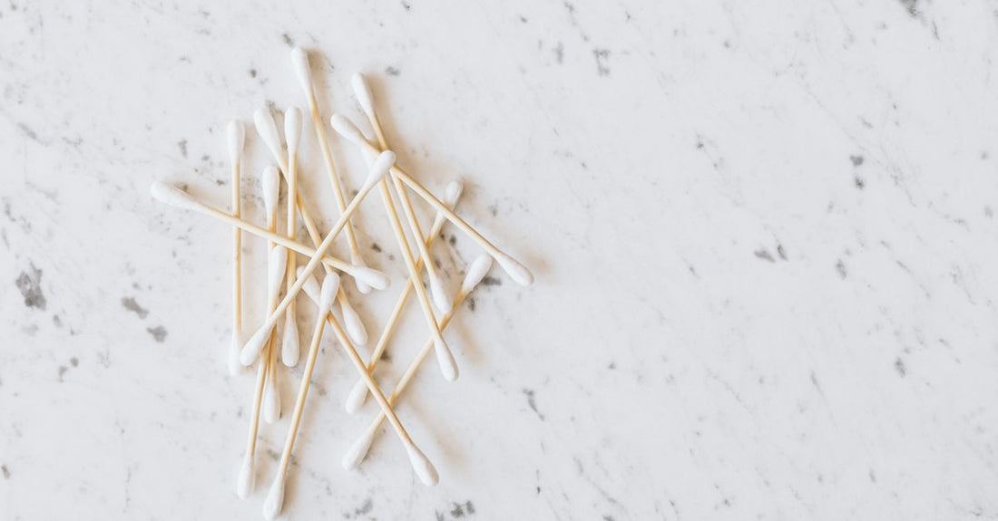 A flatlay of bamboo cotton swabs on a neutral background, illustrating a cotton swabs buying guide UK.