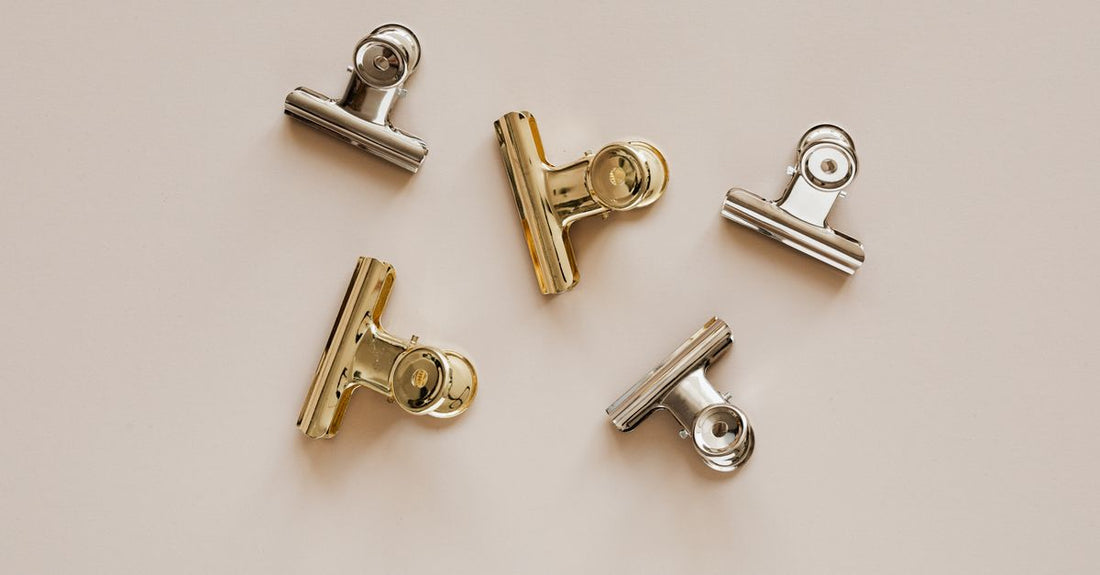 Flat lay of assorted hair claw clips in neutral tones on a white background, representing the best claws 2026 selection.