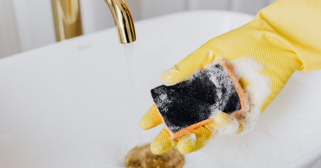 A clean makeup sponge sitting next to a solid cleansing soap on a bathroom shelf, demonstrating how to clean makeup sponges effectively.