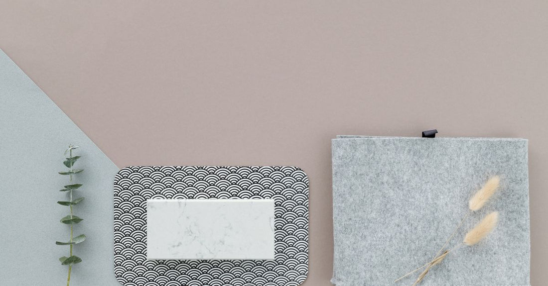 A flatlay of professional stainless steel foot files on a light marble surface, showcasing different grits and handle designs for a foot files buying guide.