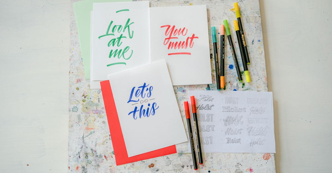 A flatlay of colourful nail art pens with fine tips on a white background, illustrating how to choose nail art pens for precise DIY designs.
