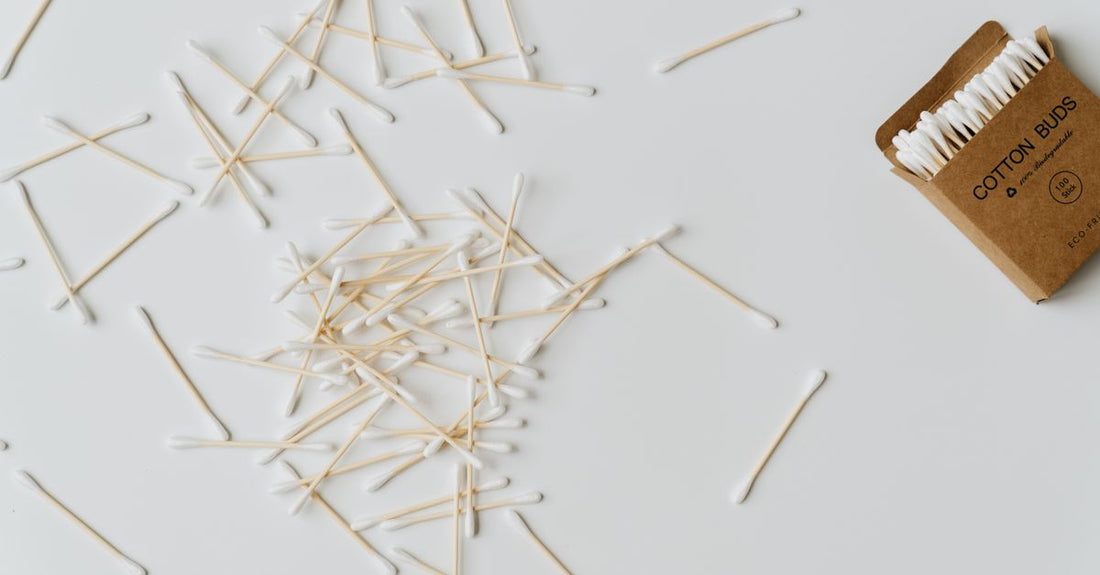 A flatlay of various cotton swabs with different tip shapes and materials, illustrating a cotton swabs buying guide for beauty routines.