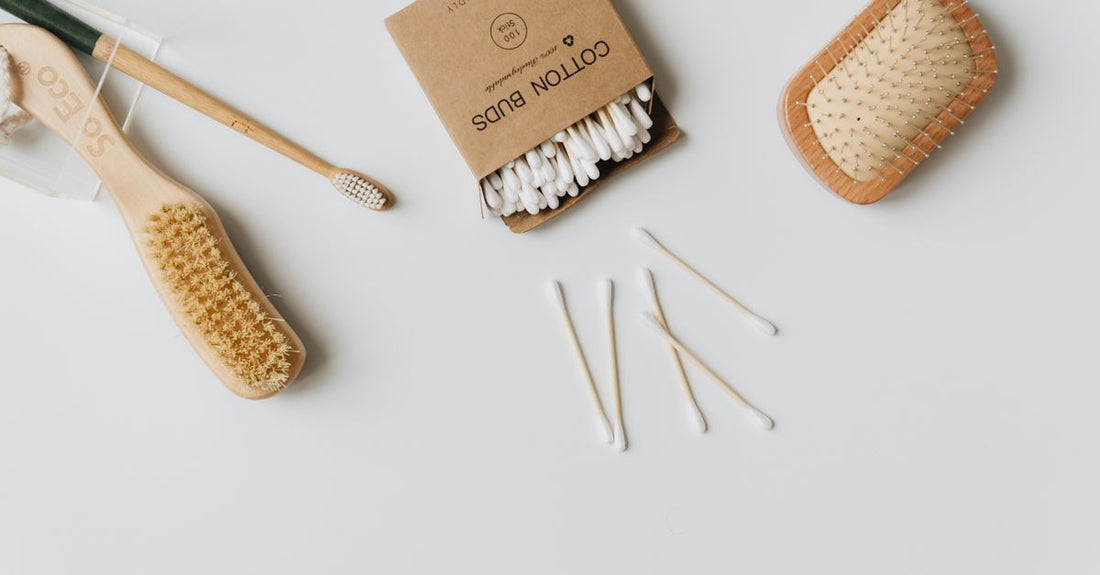 A selection of bamboo and paper-stem cotton swabs arranged on a neutral surface, illustrating how to choose cotton swabs by material and tip shape.