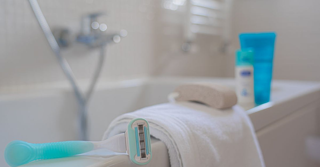 A collection of hair care products including shampoo and conditioner bottles on a bathroom shelf, illustrating how often should you wash your hair for optimal hair health.