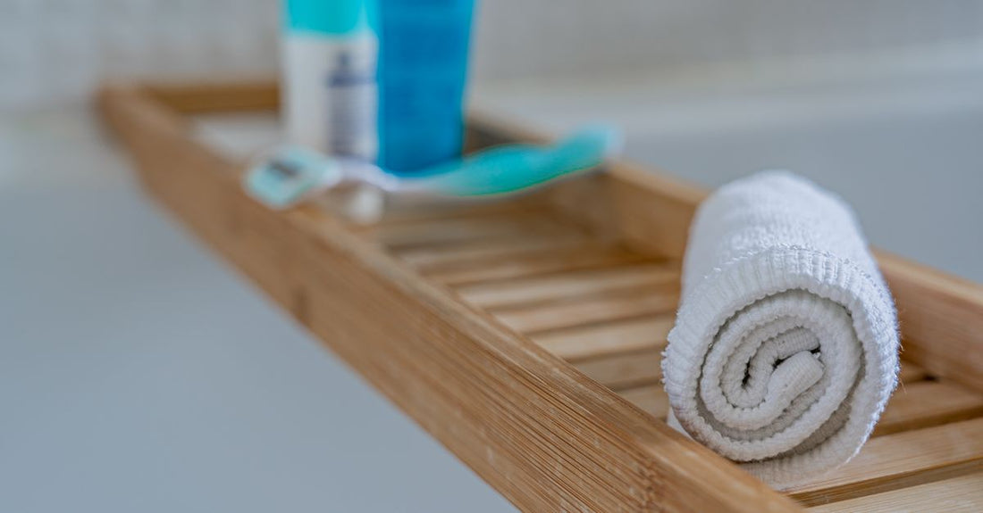 A row of antiperspirant roll-on bottles and sticks lined up on a white bathroom shelf, illustrating how to choose antiperspirants UK.