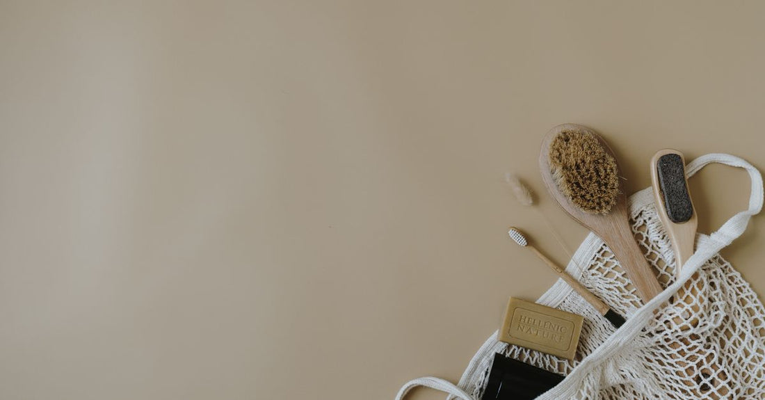 Assorted bath and body brushes laid flat on a clean white surface, illustrating how to choose the right exfoliating tool.