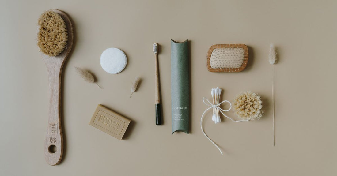 Natural bristle bath brush with long bamboo handle on a clean bathroom shelf, demonstrating how to use a bath brush for dry skin.