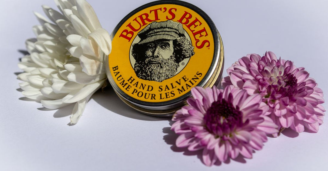 A pot of rich skincare balm on a marble surface, illustrating a balms buying guide for skin barrier repair.