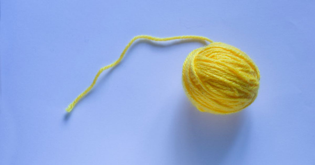 A pile of fluffy white cotton balls on a clean surface, illustrating a cotton balls buying guide.