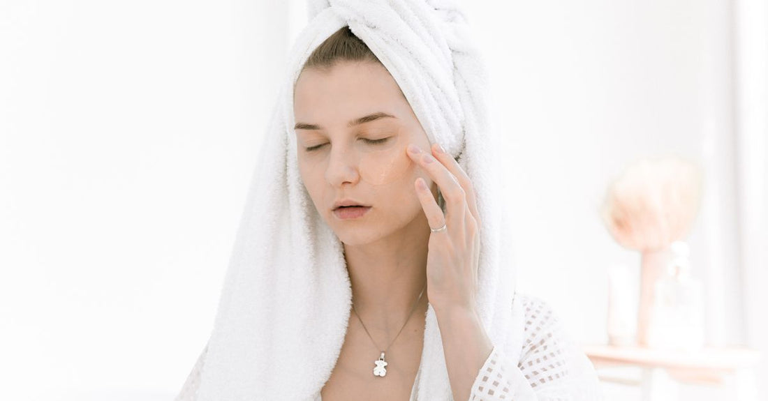 A flatlay of skincare products on a white marble surface, illustrating a face buying guide for UK shoppers.