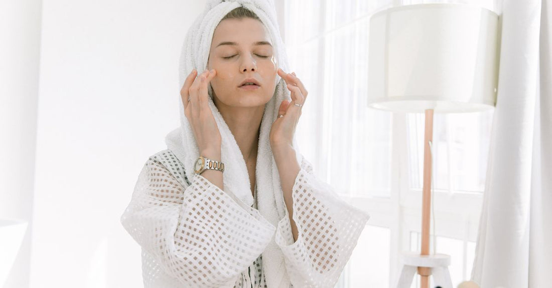 Arrangement of face skincare bottles and jars on a marble surface, illustrating how to choose face products wisely.