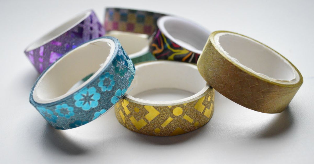 Roll of double-sided hair extension tape on a white background, demonstrating how to choose adhesives for secure hold.