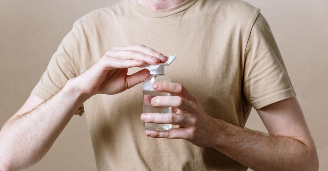Bottle of micellar water and a cotton pad to show how to remove waterproof mascara gently.