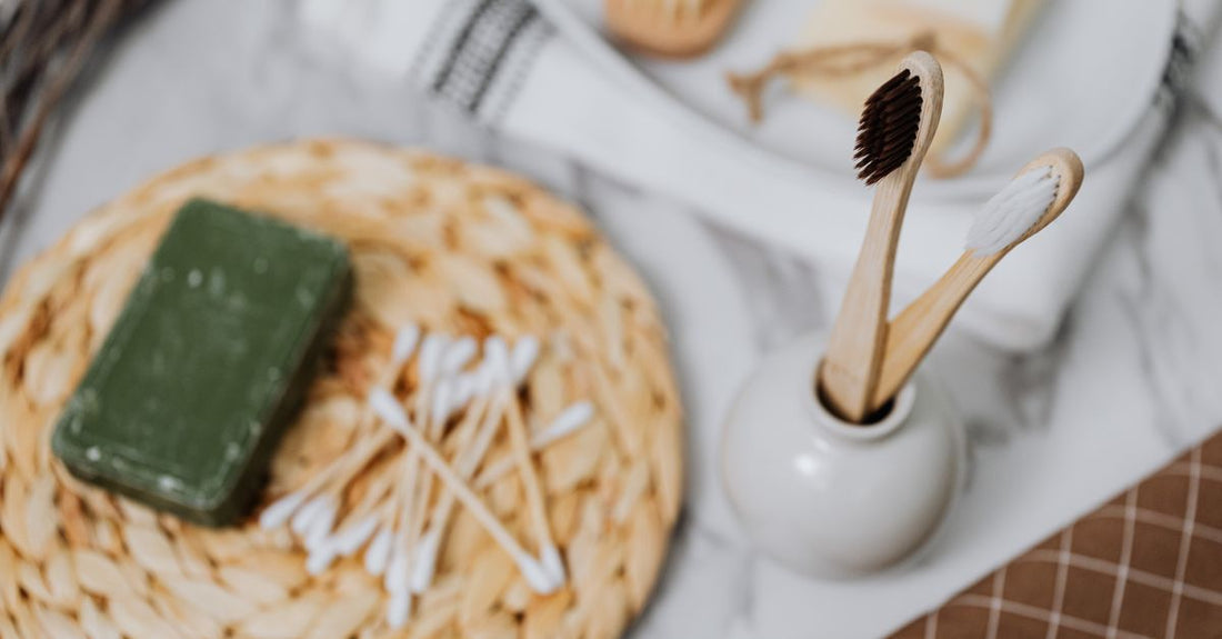 An assortment of high-quality biodegradable bamboo cotton swabs arranged on a clean, neutral background, illustrating the best cotton swabs 2026 for beauty and skincare.