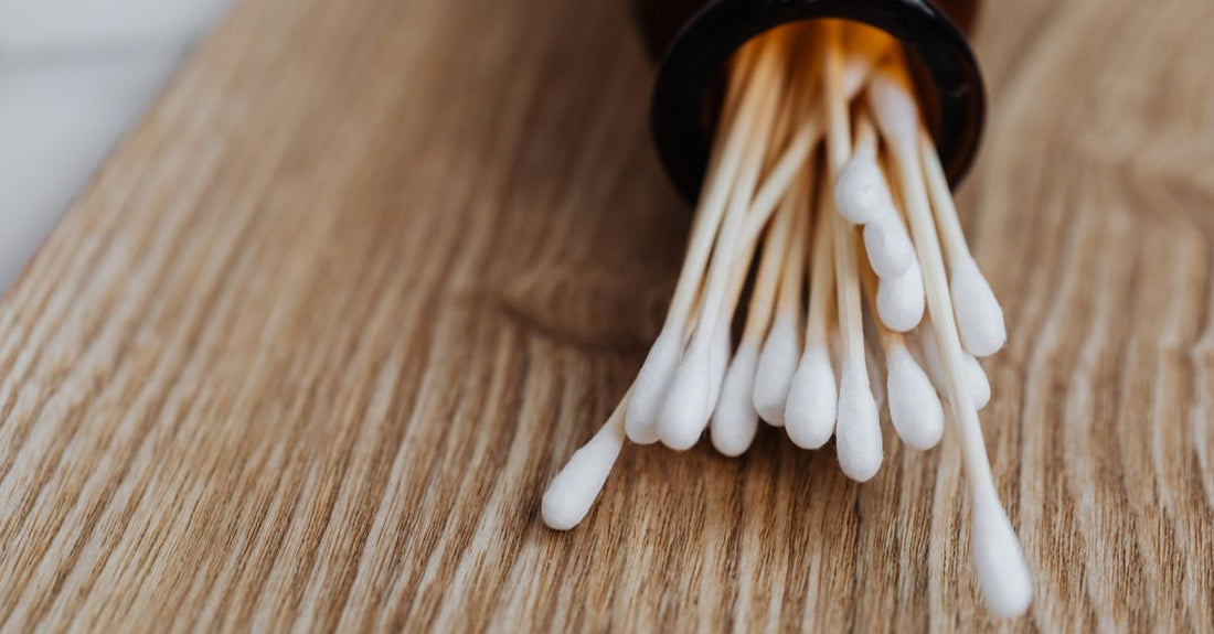 A flatlay of various cotton swabs with bamboo and paper sticks, showing different tip shapes.